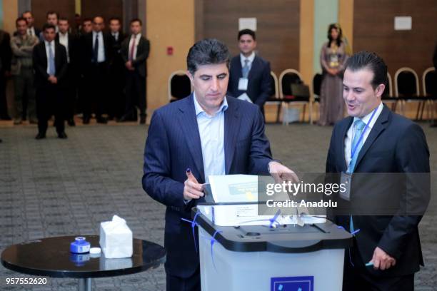 Prime Minister of Iraqi Kurdish Regional Government , Nechirvan Barzani puts his ballot paper in an electronic box following casting his vote for the...