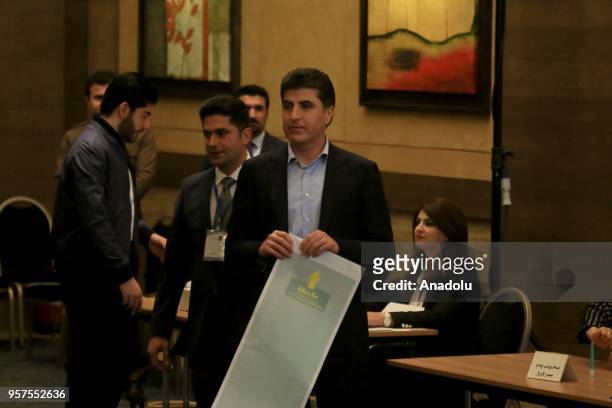 Prime Minister of Iraqi Kurdish Regional Government , Nechirvan Barzani puts his ballot paper in an electronic box following casting his vote for the...