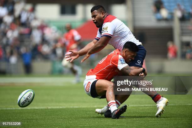 Reds' prop Taniela Tupou is tackled by Sunwolves' centre Timothy Lafaele during the Round 13 Super Rugby match between the Sunwolves of Japan and the...