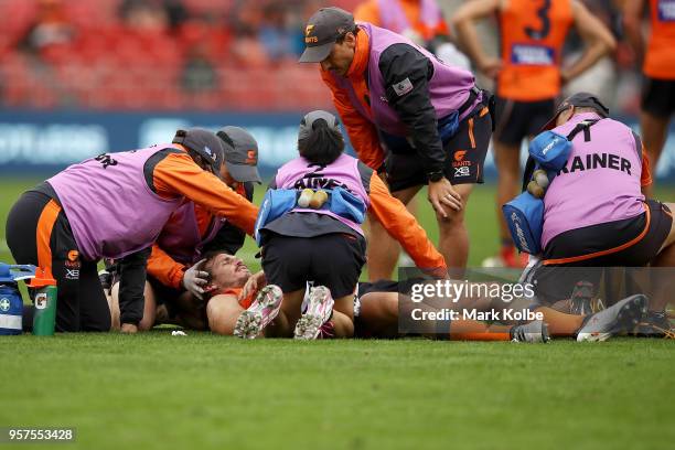 Phil Davis of the Giants receives attention from the trainers during the round eight AFL match between the Greater Western Giants and the West Coast...