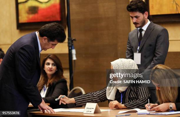 Nechirvan Barzani , Prime Minister of Iraq's autonomous Kurdistan Regional Government , registers to cast his vote at a polling station in the...