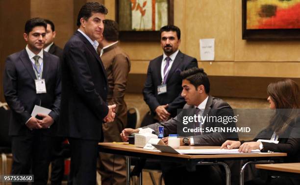 Nechirvan Barzani , Prime Minister of Iraq's autonomous Kurdistan Regional Government , registers to cast his vote at a polling station in the...