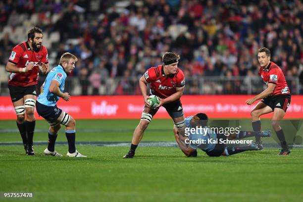 Scott Barrett of the Crusaders is tackled by Kurtley Beale of the Waratahs during the round 12 Super Rugby match between the Crusaders and the...