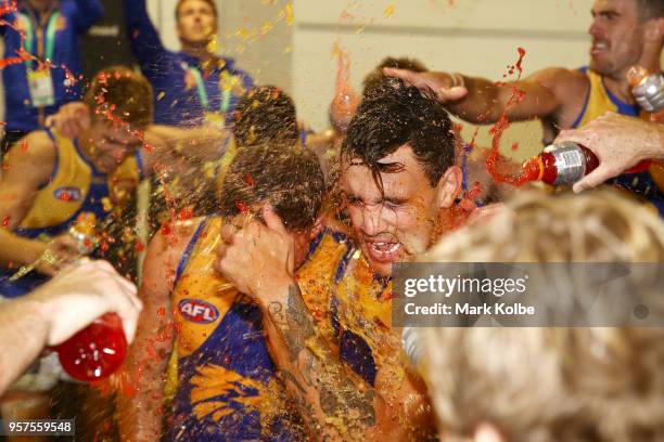 Brayden Ainsowrth and Brendan Ah Chee of the Eagles are showered by their team mates as they celebrate victory during the round eight AFL match...