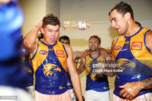 Brayden Ainsowrth and Brendan Ah Chee of the Eagles are showered by their team mates as they celebrate victory during the round eight AFL match...