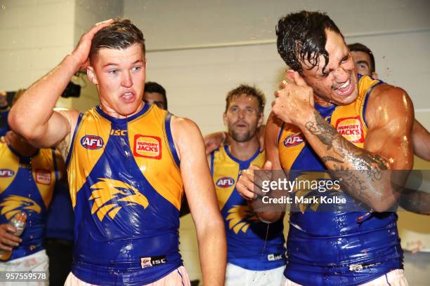 Brayden Ainsowrth and Brendan Ah Chee of the Eagles are showered by their team mates as they celebrate victory during the round eight AFL match...