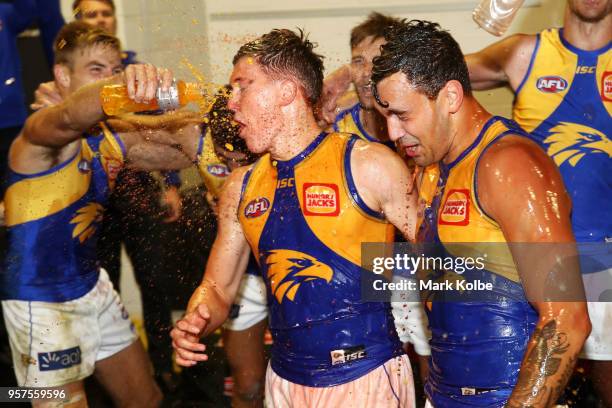 Brayden Ainsowrth and Brendan Ah Chee of the Eagles are showered by their team mates as they celebrate victory during the round eight AFL match...