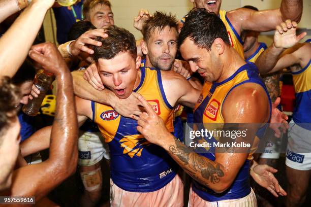 Brayden Ainsowrth and Brendan Ah Chee of the Eagles and their team mates sing the team song as they celebrate victory during the round eight AFL...