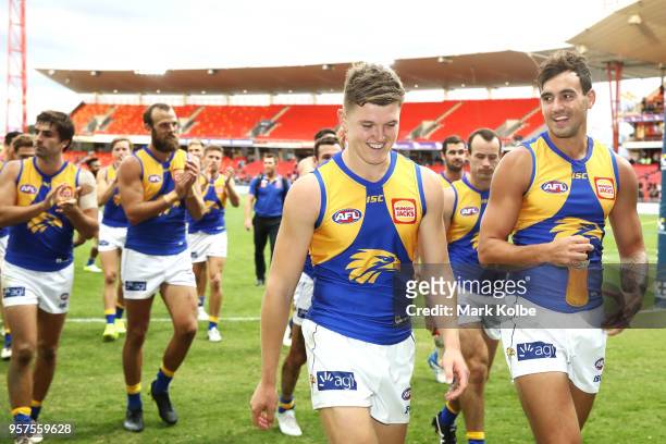 Brayden Ainsowrth and Brendan Ah Chee of the Eagles lead their team off the field as they celebrate victory during the round eight AFL match between...