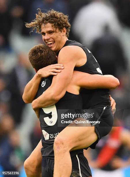 Charlie Curnow and Patrick Cripps of the Blues celebrate winning the round eight AFL match between the Carlton Blues and the Essendon Bombers at...