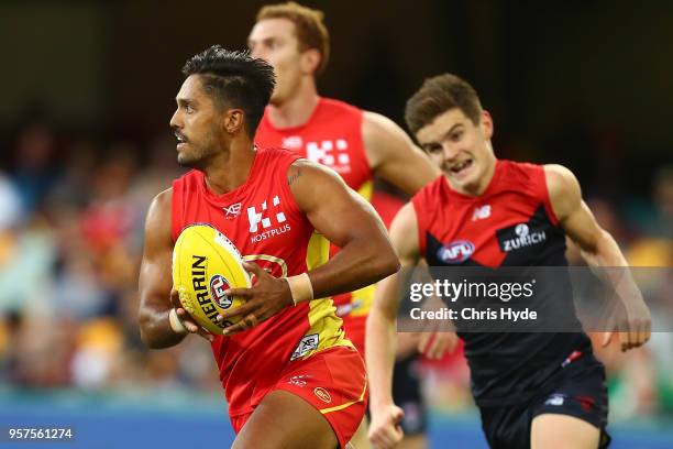 Aaron Hall of the Suns runs the ball during the round eight AFL match between the Gold Coast Suns and the Melbourne Demons at The Gabba on May 12,...