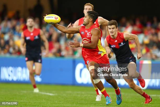Aaron Hall of the Suns runs the ball during the round eight AFL match between the Gold Coast Suns and the Melbourne Demons at The Gabba on May 12,...