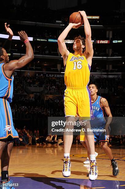 Pau Gasol of the Los Angeles Lakers shoots a jump shot against Jeff Green and Thabo Sefolosha of the Oklahoma City Thunder during the game at Staples...