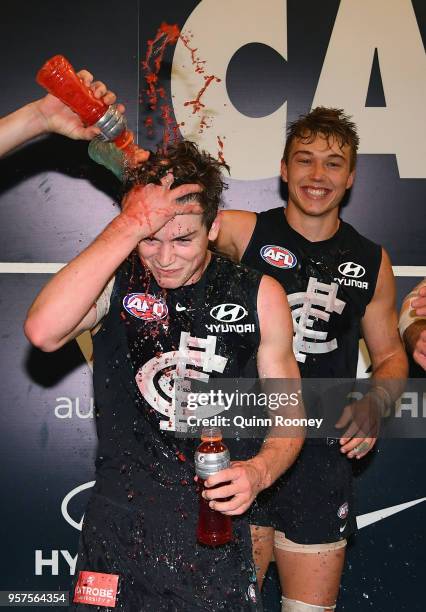 Paddy Dow of the Blues is sprayed with drinks as the Blues celebrate winning the round eight AFL match between the Carlton Blues and the Essendon...