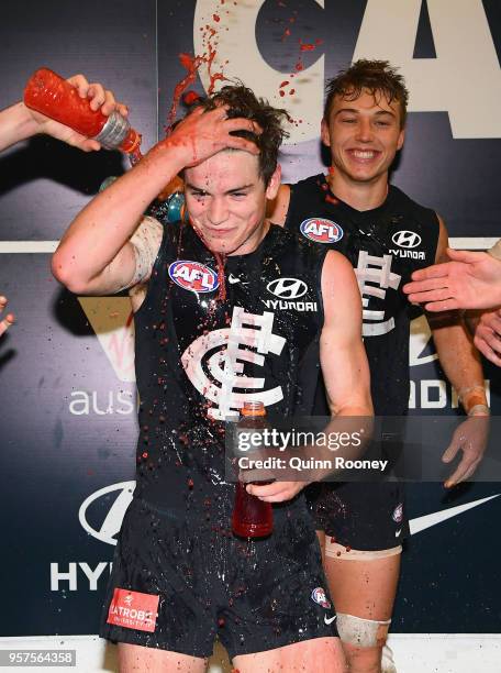 Paddy Dow of the Blues is sprayed with drinks as the Blues celebrate winning the round eight AFL match between the Carlton Blues and the Essendon...