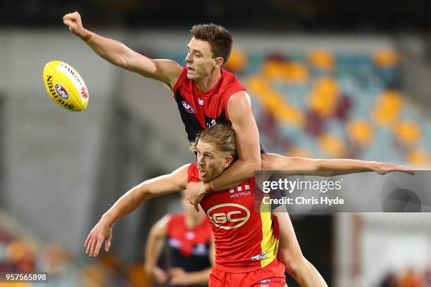 Aaron Young of the Suns and Jake Lever of the Demons compete for the ball during the round eight AFL match between the Gold Coast Suns and the...