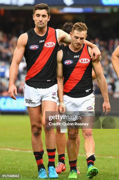 David Myers and Devon Smith of the Bombers look dejected after losing the round eight AFL match between the Carlton Blues and the Essendon Bombers at...