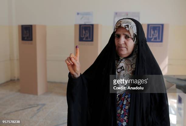 An Iraqi woman poses for a photo after casting her vote for the Iraqi parliamentary election in Erbil, Iraq on May 12, 2018.