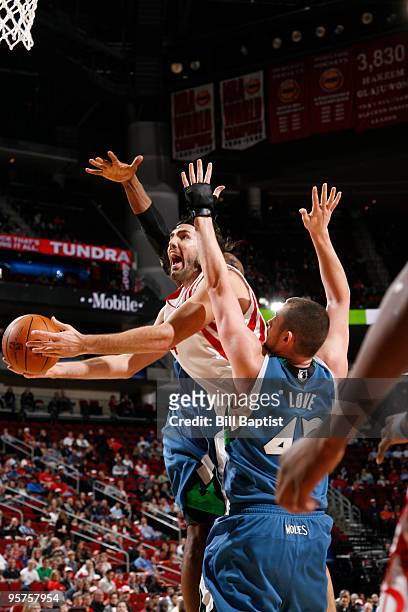Luis Scola of the Houston Rockets shoots the ball over Kevin Love of the Minnesota Timberwolves on January 13, 2010 at the Toyota Center in Houston,...
