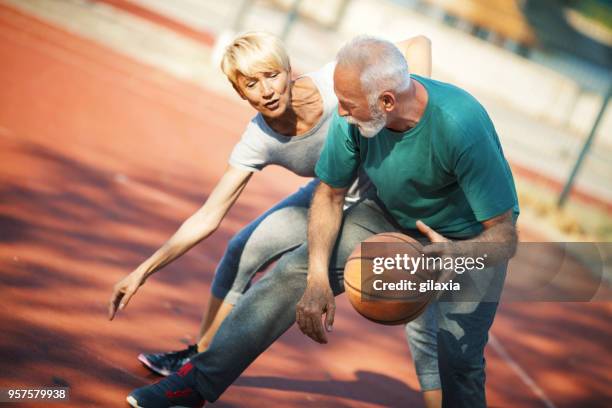 seniors playing basketball. - old basketball hoop stock pictures, royalty-free photos & images