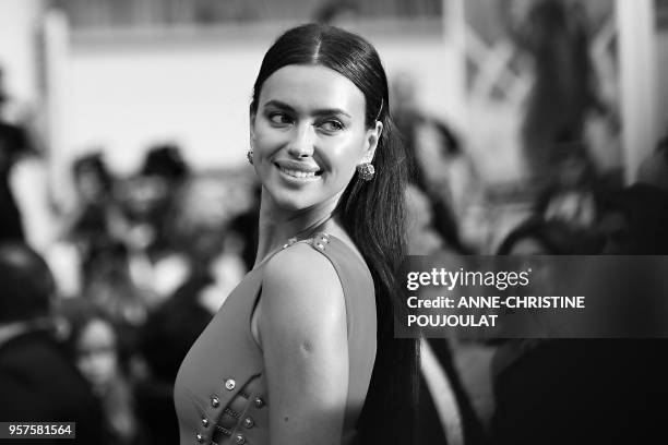 VERSIONRussian model Irina Shayk poses as she arrives on May 10, 2018 for the screening of the film "Sorry Angel " at the 71st edition of the Cannes...
