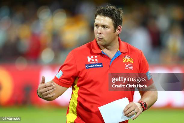 Suns coach Stuart Dew looks on during the round eight AFL match between the Gold Coast Suns and the Melbourne Demons at The Gabba on May 12, 2018 in...