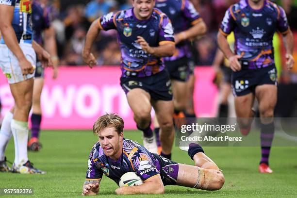 Cameron Munster of the Storm scores a try during the round ten NRL match between the Melbourne Storm and the Gold Coast Titans at Suncorp Stadium on...