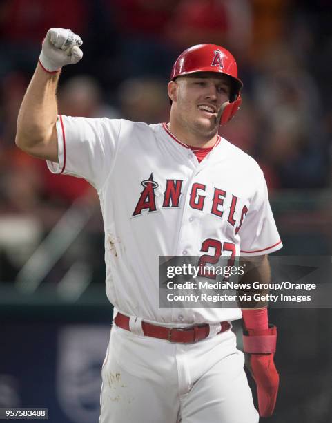 The Angels' Mike Trout celebrates Albert Pujols' 2999th career hit against the Baltimore Orioles at Angel Stadium in Anaheim on Thursday, May 3, 2018.