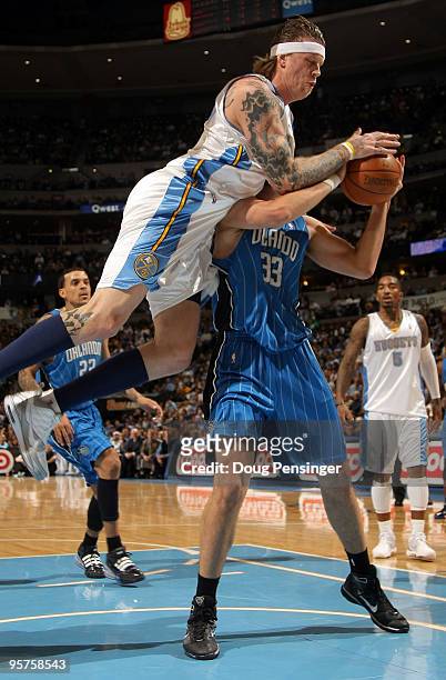 Ryan Anderson of the Orlando Magic is fouled by Chris Andersen the Denver Nuggets as he tries to get off a shot during NBA action at Pepsi Center on...