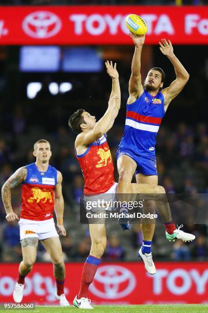 Tom Boyd of the Bulldogs compete for the ball over Stefan Martin of the Lions during the round eight AFL match between the Western Bulldogs and the...