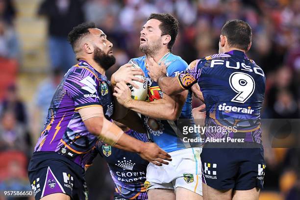 Anthony Don of the Titans is tackled during the round ten NRL match between the Melbourne Storm and the Gold Coast Titans at Suncorp Stadium on May...