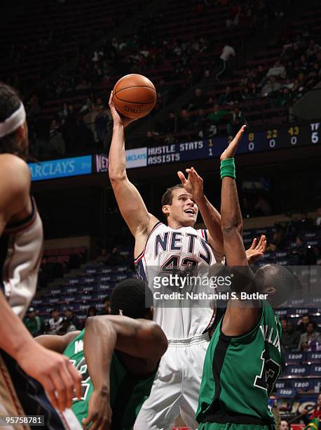 Kris Humphries of the New Jersey Nets shoots against Shelden Williams of the Boston Celtics on January 13, 2010 at the IZOD Center in East...