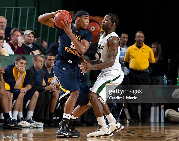 Dominique Jones of the South Florida Bulls guards Kevin Jones of the West Virginia Mountaineers during the game at the SunDome on January 13, 2010 in...