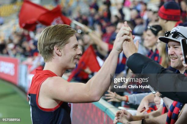 Charlie Spargo of the Demons celebrates with fans during the round eight AFL match between the Gold Coast Suns and the Melbourne Demons at The Gabba...