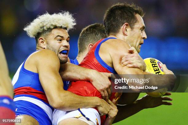 Jason Johannisen of the Bulldogs tackles Luke Hodge of the Lions during the round eight AFL match between the Western Bulldogs and the Brisbane Lions...