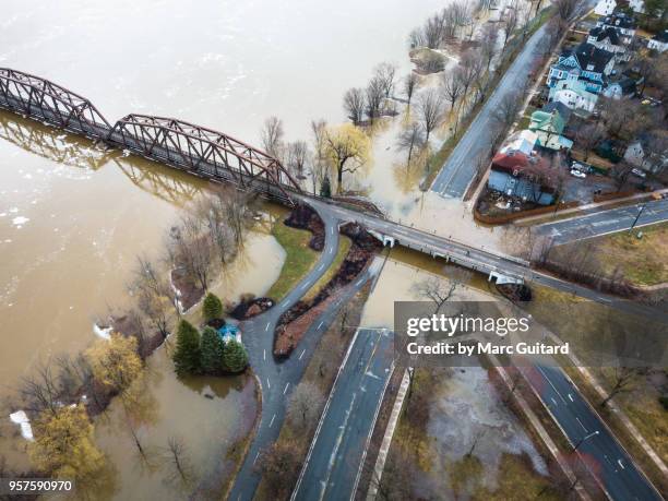 saint john river flooding at the walking bridge in the spring of 2018 in fredericton, new brunswick, canada - brunswick centre stock pictures, royalty-free photos & images