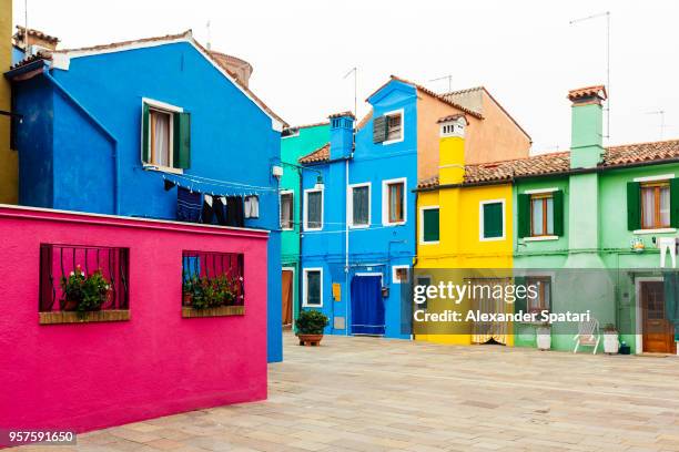 multi colored houses in burano village, veneto, italy - colour saturation foto e immagini stock