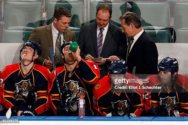 Assistant Coach Jim Hulton of the Florida Panthers talks with Head Coach Peter DeBoer and Assistant Coach Mike Kitchen during the game against the...