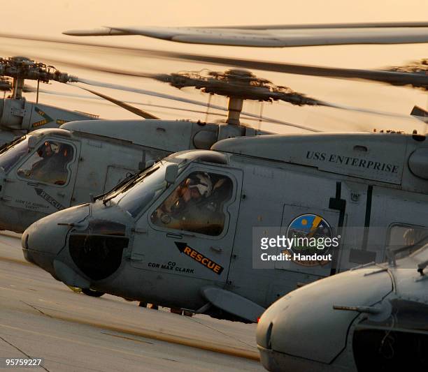 In this handout image provided by the U.S. Navy, Sea Hawk helicopters depart Naval Air Station Jacksonville to embark aboard the aircraft carrier USS...