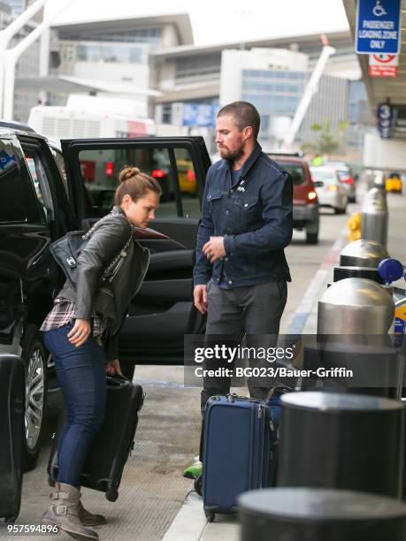 Stephen Amell and Cassandra Jean are seen at Los Angeles International Airport on May 11, 2018 in Los Angeles, California.