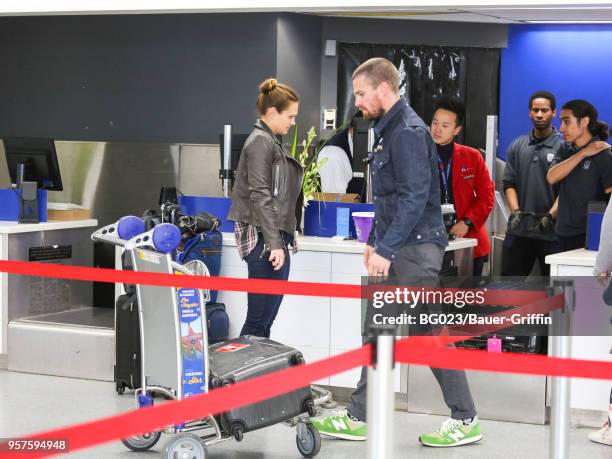 Stephen Amell and Cassandra Jean are seen at Los Angeles International Airport on May 11, 2018 in Los Angeles, California.