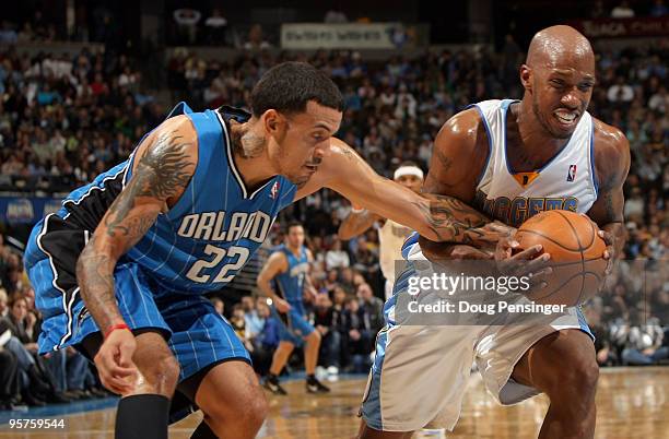 Chauncey Billups of the Denver Nuggets is fouled by Matt Barnes of the Orlando Magic during NBA action at Pepsi Center on January 13, 2010 in Denver,...