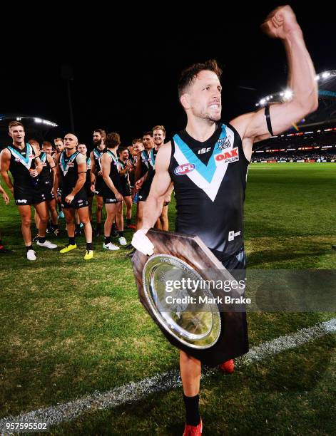 Travis Boak captain of Port Adelaide celebrates to the fans after receiving the Showdown trophy during the round eight AFL match between the Port...