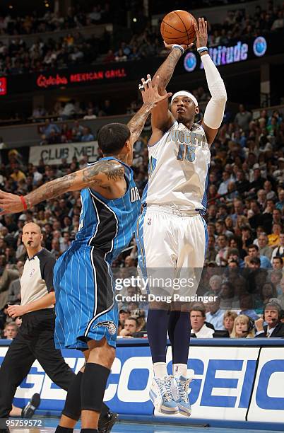 Carmelo Anthony of the Denver Nuggets take a shot over Matt Barnes of the Orlando Magic during NBA action at Pepsi Center on January 13, 2010 in...