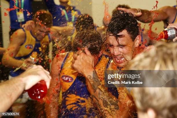 Brayden Ainsowrth and Brendan Ah Chee of the Eagles are showered by their team mates as they celebrate victory during the round eight AFL match...