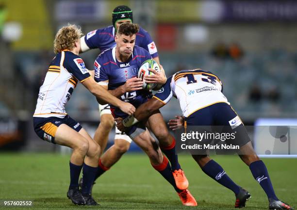 Tom English of the Rebels is tackled during the round 12 Super Rugby match between the Brumbies and the Rebels at GIO Stadium on May 12, 2018 in...