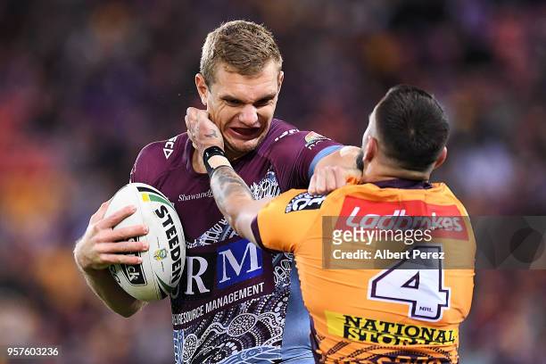 Tom Trbojevic of the Sea Eagles fends off a tackle from Jack Bird of the Broncos during the round ten NRL match between the Manly Sea Eagles and the...