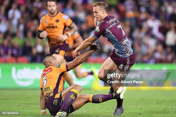 Daly Cherry-Evans of the Sea Eagles evades a tackle from Jamayne Isaako of the Broncos during the round ten NRL match between the Manly Sea Eagles...