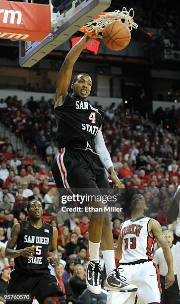 Malcolm Thomas of the San Diego State Aztecs dunks in front of teammate Kawhi Leonard and Tre'Von Willis of the UNLV Rebels during their game at the...