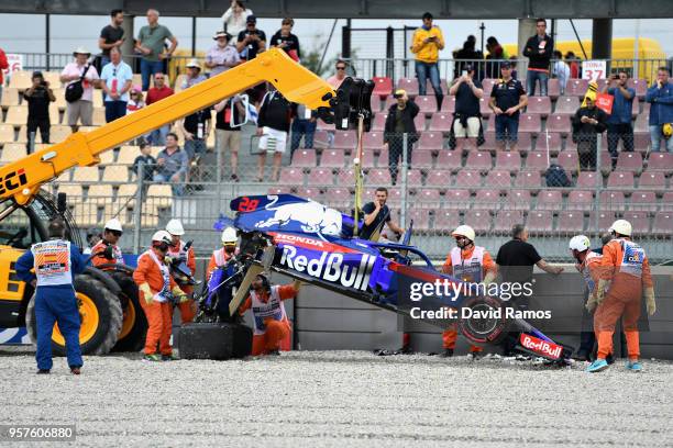 The car of Brendon Hartley of New Zealand and Scuderia Toro Rosso is recovered from the track after he crashed during final practice for the Spanish...